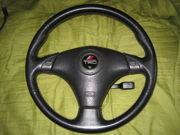 Tiptronic Facelift Supra steering wheel - buttons are used to control Suprastick manualised gear changes. 

The centre is from a Celica with the airbag removed and finished off with a TRD horn badge