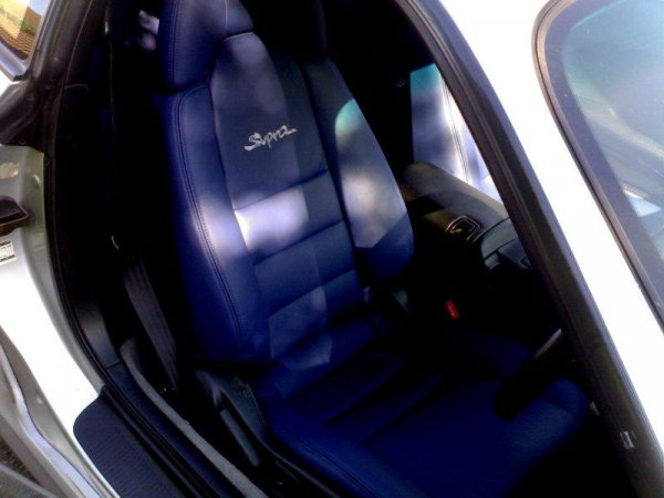 Driver side re-trimmed blue leather seat with embroidered Supra logo.