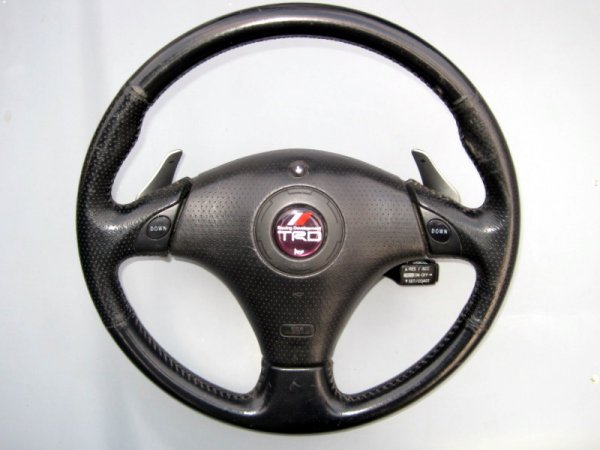 Tiptronic Facelift Supra steering wheel  and Lexus IS 250 flappy paddles and buttons are used to control Suprastick manualised gear changes. 

The centre is from a Celica with the airbag removed and